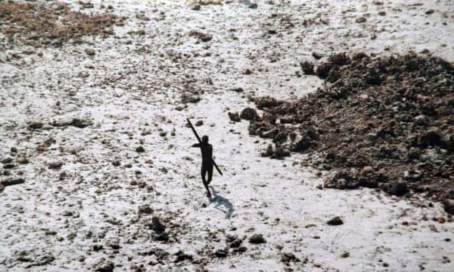 A tribesman aims his bow and arrow at an Indian coastguard helicopter over North Sentinel island.