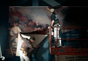 Workers hang a mural depicting the Battle of Bunker Hill as preparations for opening continue at the Museum of the American Revolution in Philadelphia.