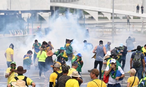 teargas in the air as people cover faces