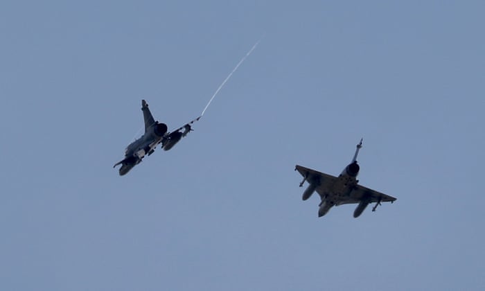 Two Taiwanese Air Force Mirage 2000-5 fighter jets fly by an airbase in Hsinchu, Taiwan, 7 August.