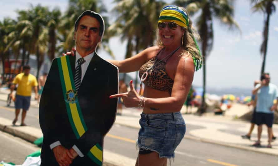 A demonstrator holds a cardboard cutout depicting Brazilian President Jair Bolsonaro in Rio de Janeiro, Brazil, on 8 December .