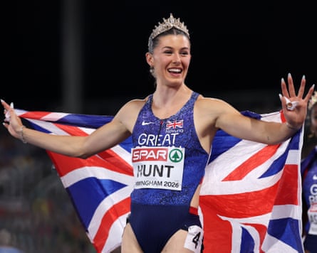 Amy Hunt celebrates while wearing a tiara and the national flag, after victory in the Mixed 4x100m Relay Final.