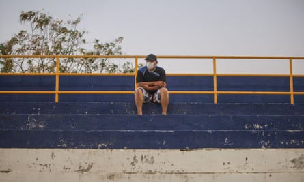 A fan with a face mask watches Managua take on Diriangén.