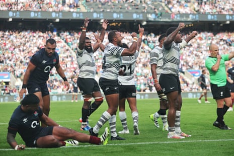 Fiji players celebrate victory following the Summer International match against England at Twickenham.