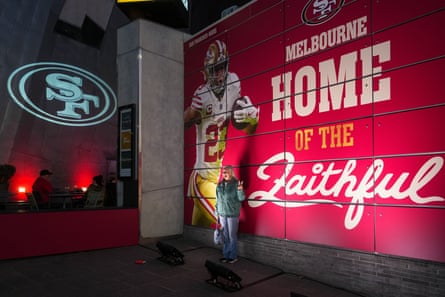 A fan poses for a photo outside the official fan bar for the 49ers