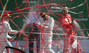 Lewis Hamilton, centre, celebrates his victory at Monza with his second-placed Mercedes team-mate Valtteri Bottas and Sebastian Vettel, who was third.