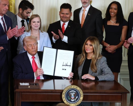 Donald Trump, joined by first lady Melania Trump, signs an executive order in the East Room of the White House, 13 November 2025.