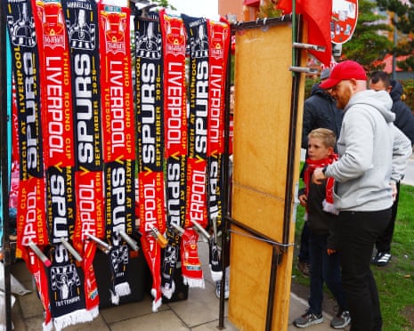 Match day scarves are sold ahead of the Liverpool v Tottenham Hotspur Carabao Cup match.