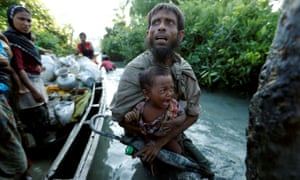 Rohingya people arrive on the Bangladeshi side of the Naf river after crossing the border from Myanmar, in Palang Khali