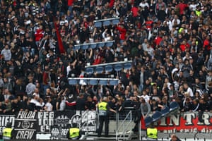 Fans of Eintracht Frankfurt remove seats so they can stand while watching the game.