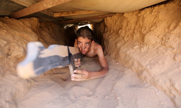 A Palestinian crawls through a tunnel during a military-style exercise at a summer camp organised by the Islamic Jihad Movement in Khan Younis, Gaza Strip.