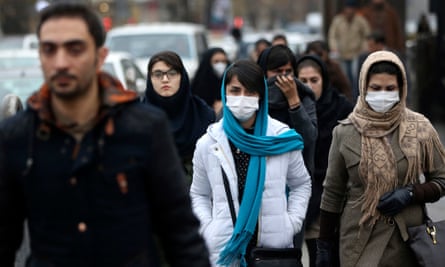 Iranian women wear masks for protection against air pollution as they make their way on a street in northern Tehran, Iran, Sunday, Dec. 20, 2015
