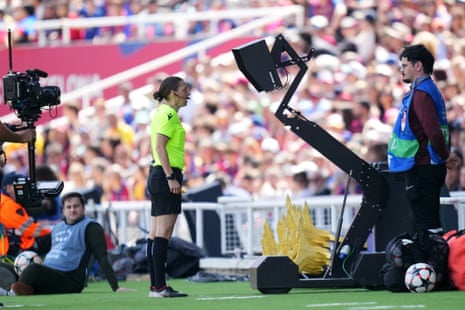 Referee Stephanie Frappart reviews the VAR monitor during the Women's Champions League 2023/24 semi-final first leg between Barcelona and Chelsea.