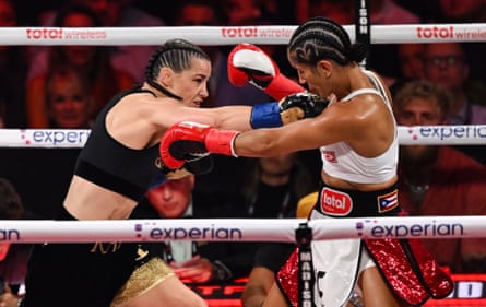 Katie Taylor, left, lands a right hand on Amanda Serrano during Friday’s fight.