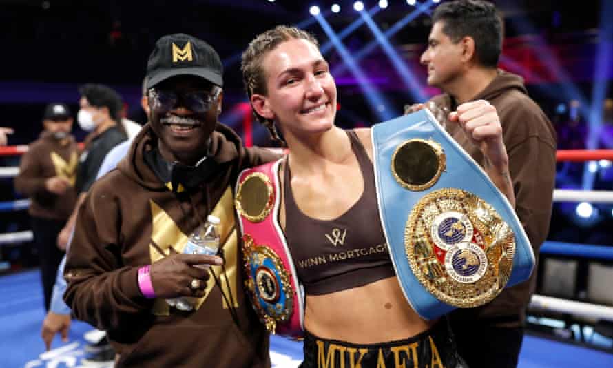 WBO junior lightweight champion Mikaela Mayer poses with her trainer Al Mitchell (left) after her unanimous decision victory over IBF champion Mavia Hamadouche in a title unification fight at Virgin Hotels Las Vegas on 5 November 2021 in Las Vegas, Nevada.