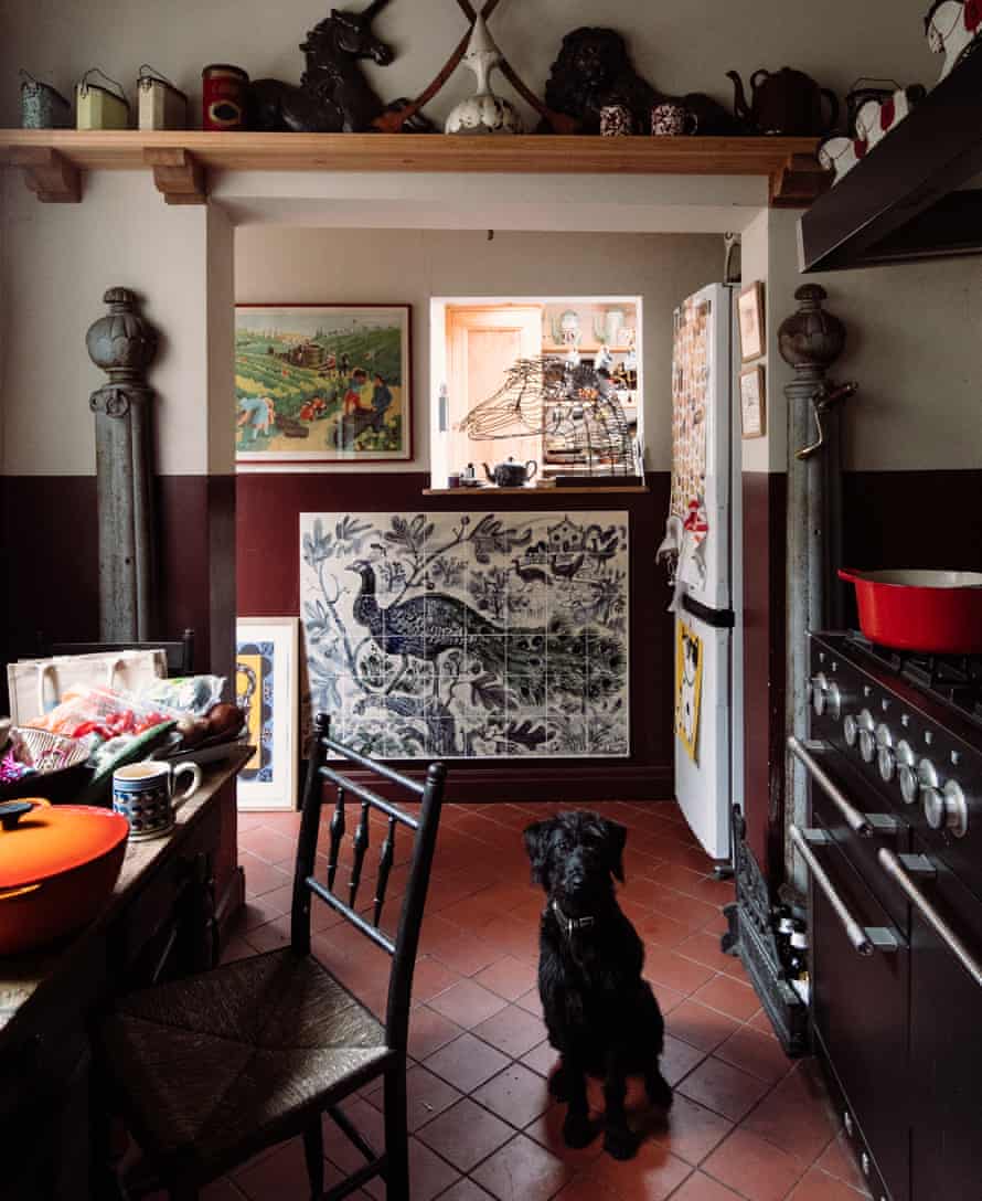 Peacock tiles in the kitchen and her pet dog.