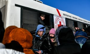 Evacuees from Mariupol get off one of 15 busses that carried them towards Berdiansk and arrived to Zaporizhzhia, southeastern Ukraine