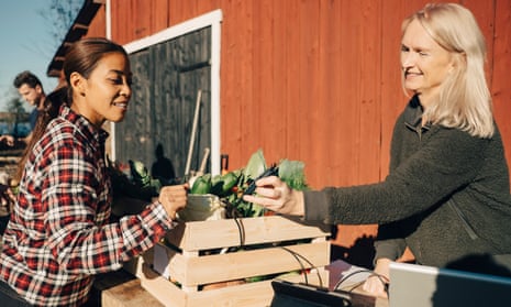 A customer pays with a card at a market in Sweden