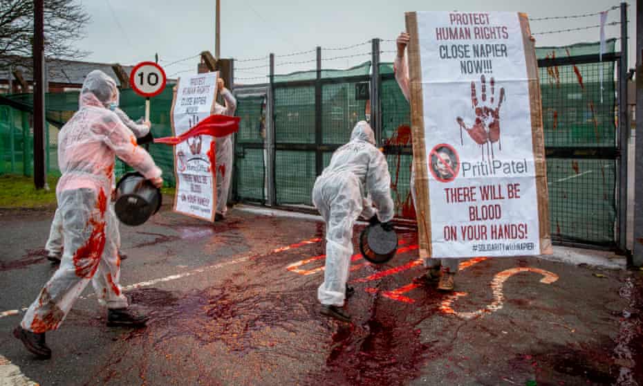 Activists throw buckets of fake blood at Napier barracks in Kent