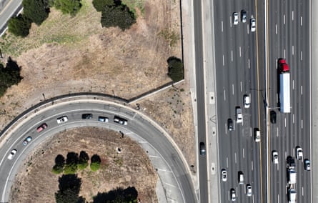 Traffic moves along the 10-lane Interstate 80 freeway as more cars flow down a looping on-ramp.
