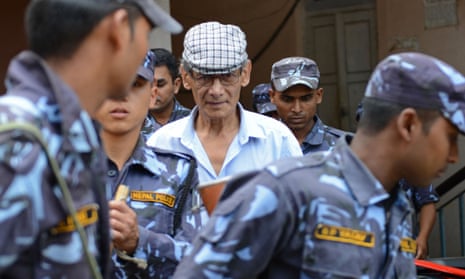 Charles Sobhraj is escorted by Nepalese police at a district court hearing in June 2014