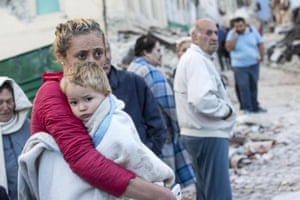 A mother embraces her son in Amatrice