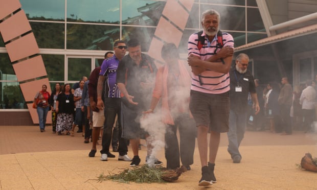 Ernie Dingo and other attendees walk through smoke to be cleansed at a ceremony to open Australia’s first Indigenous suicide prevention conference in Alice Springs in 2016.
