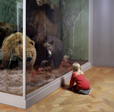 Girl with Bears, Royal Museum of Scotland, Edinburgh, 1999. A girl kneels on the floor in front of a glass case containing at least three large stuffed wild bears