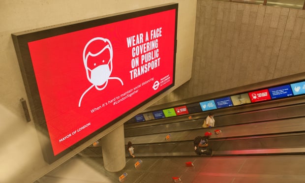 An electronic sign in London informing people that face coverings are now compulsory on public transport in England.