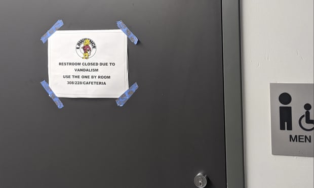 A sign on a closed restroom at Lawrence high school informs students of the vandalism that has been attributed to the viral ‘devious licks’ challenge on TikTok.