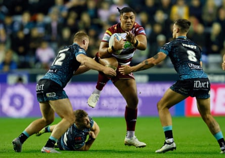Wigan’s Patrick Mago (centre) attempts to get past Leigh Leopards’ Jack Hughes (left) and Owen Trout during the Super League playoff semi-final.