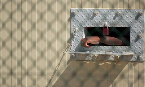 A detainee’s arm hangs outside his cell at a security prison on the US naval station in Guantanamo Bay in 2005