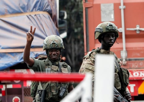 M23 rebel fighters at a border crossing point in Rwanda