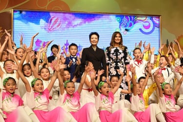 First Lady Melania Trump and China’s First Lady Peng Liyuan with students in pink in front of them