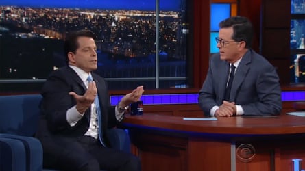 Anthony Scaramucci sitting on a dark-blue sofa in a TV studio, gesticulating as he talks to talkshow host Stephen Colbert, who is sitting at a brown desk