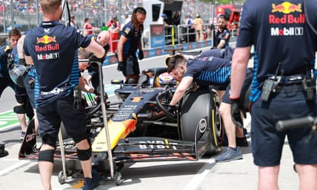 Red Bull mechanics work on Max Verstappen’s car.