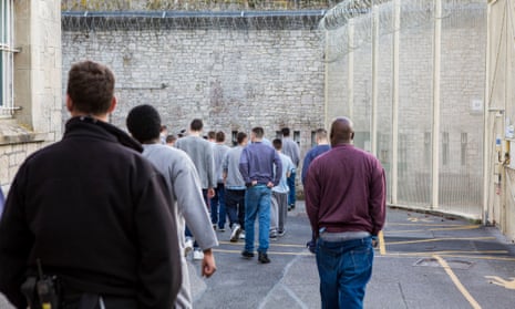 A picture of young offenders moving around a prison