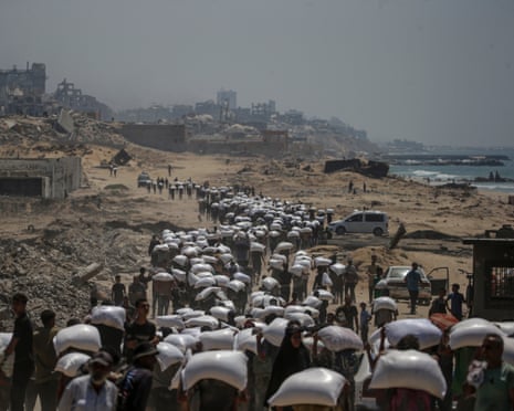 Displaced Palestinians near a food distribution point in the northern Gaza, 27 July 2025