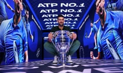 Novak Djokovic poses with the ATP Year End World Number One Trophy in Turin