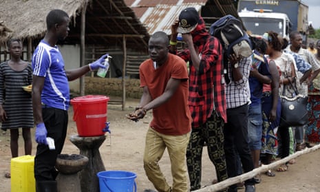 People in a village on the outskirts of Freetown leave Ebola quarantine, 12 August.