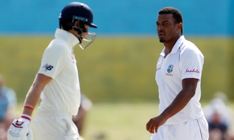 England’s Joe Root walks past the West Indies fast bowler Shannon Gabriel