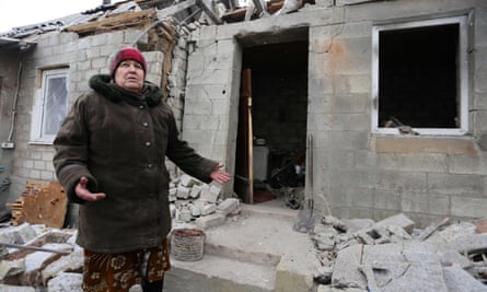 Valentina, a 73-years-old resident of Avdiivka, stands outside her home damaged during the recent shelling.
