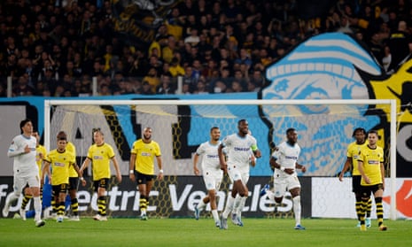 Marseille's Chancel Mbemba celebrates scoring their first goal with teammates at AEK Athens.