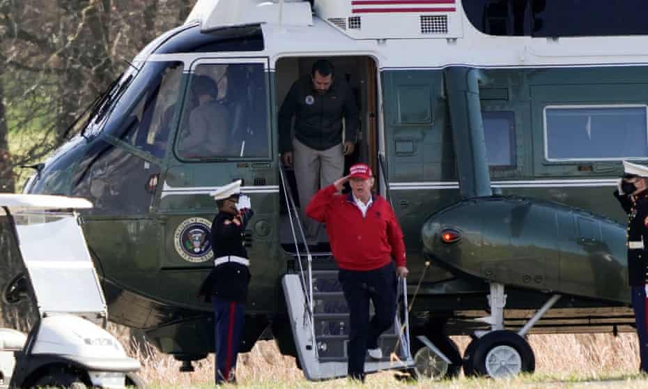Donald Trump walks out of Marine One before a round of golf on Saturday