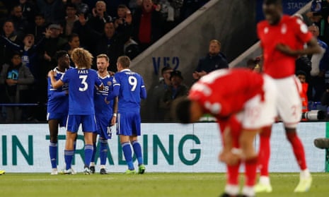 Leicester City’s James Maddison celebrates scoring their first goal with team-mates as the Nottingham Forest players look dejected.