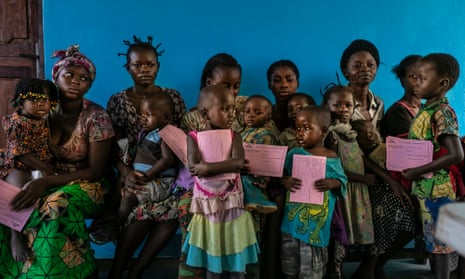Children await measles vaccinations at the Lunyeka health centre on the first day of the inoculation campaign in the Democratic Republic of the Congo