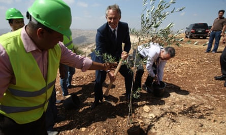 Tony Blair plants an olive tree at Rawabi in June 2010.