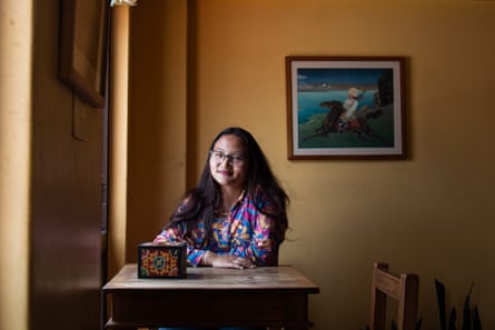 Tashi Lhazom sits at a table next to a window.