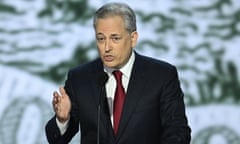 man speaking into microphone on stage