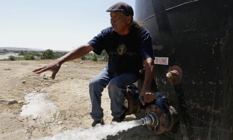Joe Ben Jr tests the water from tanks at the Chief Hill location in Shiprock, New Mexico.